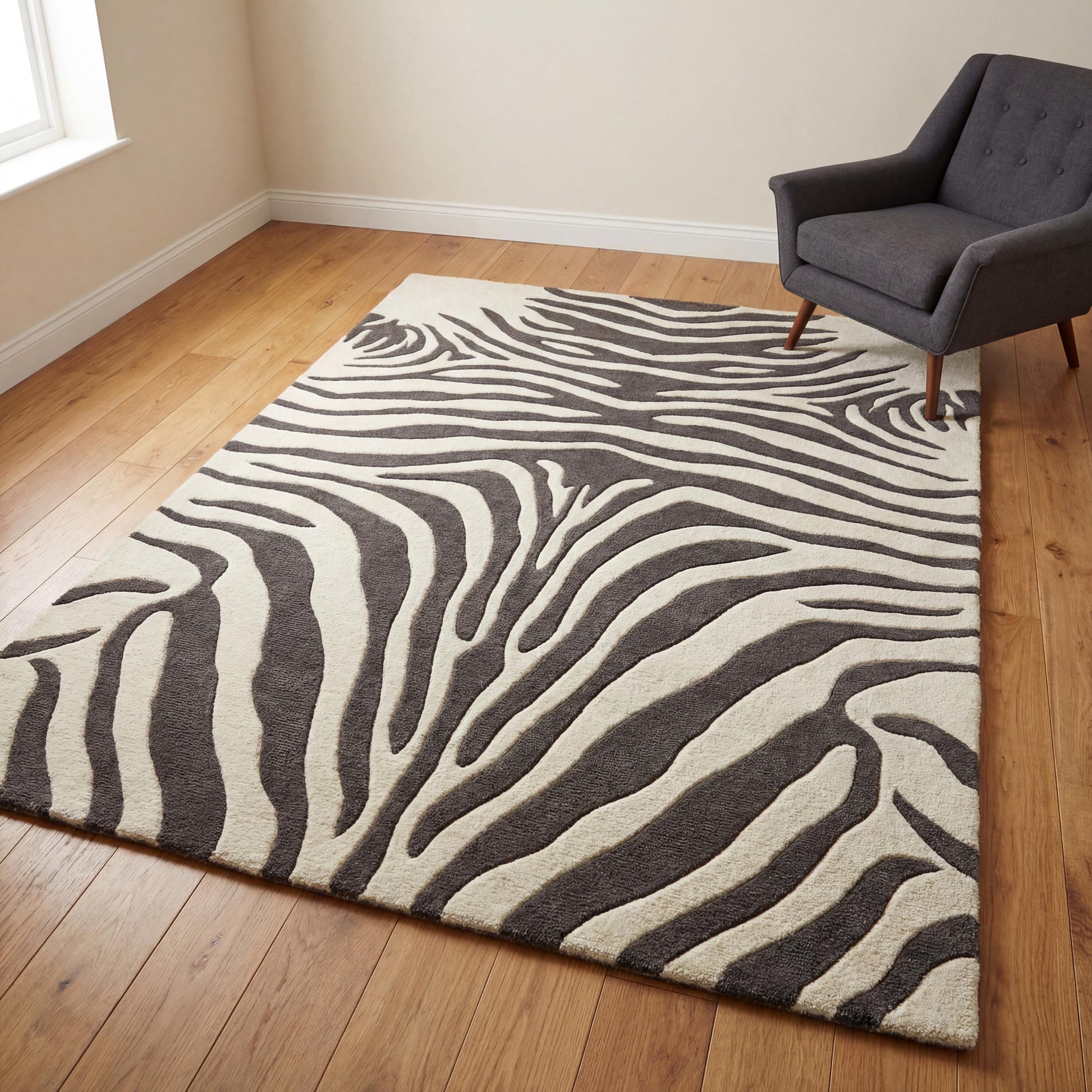 Modern ivory and charcoal zebra print hand tufted wool rug with textured 3D animal pattern for living room or bedroom.
