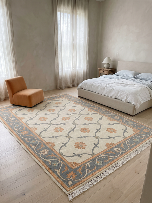 Ivory Trellis Rug with a cream field, slate blue vine lattice, peach floral motifs and a blue floral border