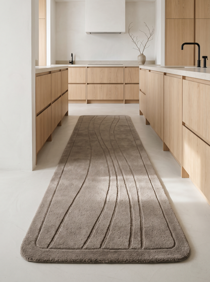 Taupe Wavy Line Runner Rug in a soft taupe tone with carved flowing lines, rounded corners and a plush wool pile