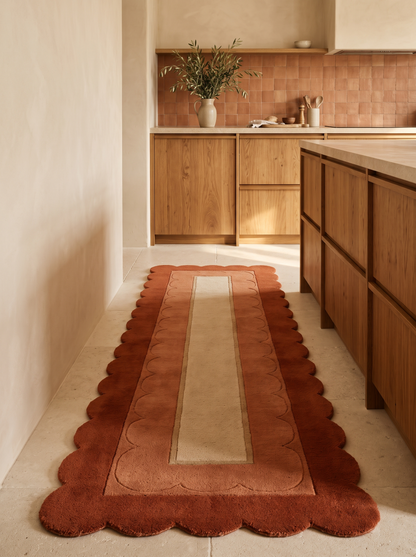 Terracotta Scalloped Runner Rug in rust and terracotta wool, with a sand centre panel and carved scallop borders