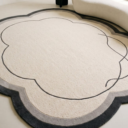 Ivory Cloud Rug in hand-tufted wool with a scalloped flower shape, ivory field, charcoal and grey border and a flowing carved charcoal line - view 5