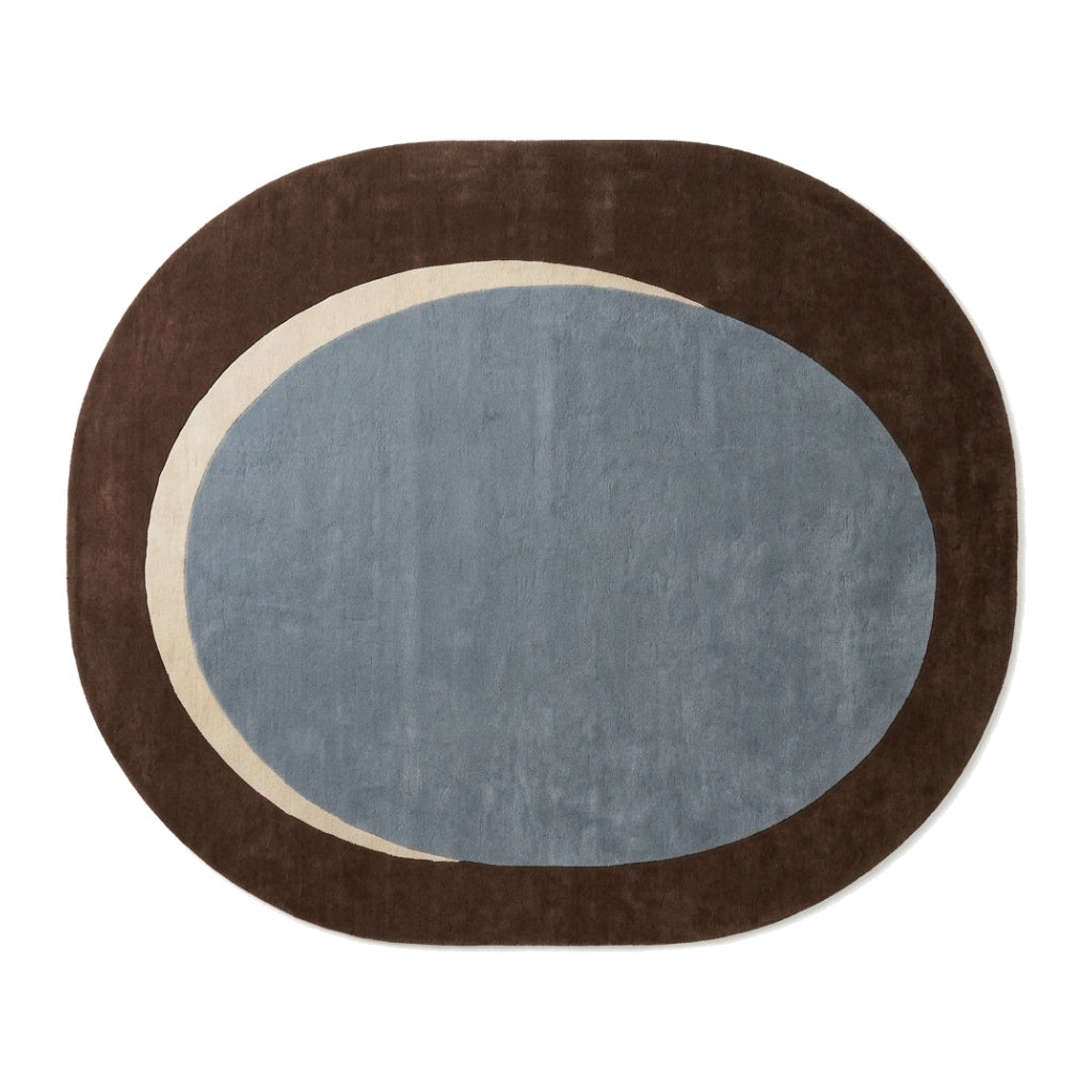 Slate Blue Oval Rug in hand-tufted wool with a slate blue oval centre, a sand crescent and a wide chocolate brown oval border - view 2