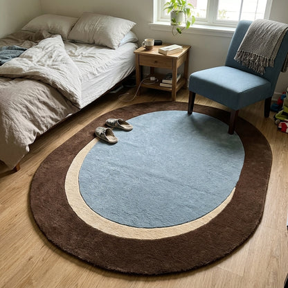Slate Blue Oval Rug in hand-tufted wool with a slate blue oval centre, a sand crescent and a wide chocolate brown oval border - view 3