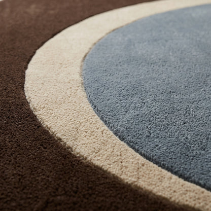 Slate Blue Oval Rug in hand-tufted wool with a slate blue oval centre, a sand crescent and a wide chocolate brown oval border - view 4