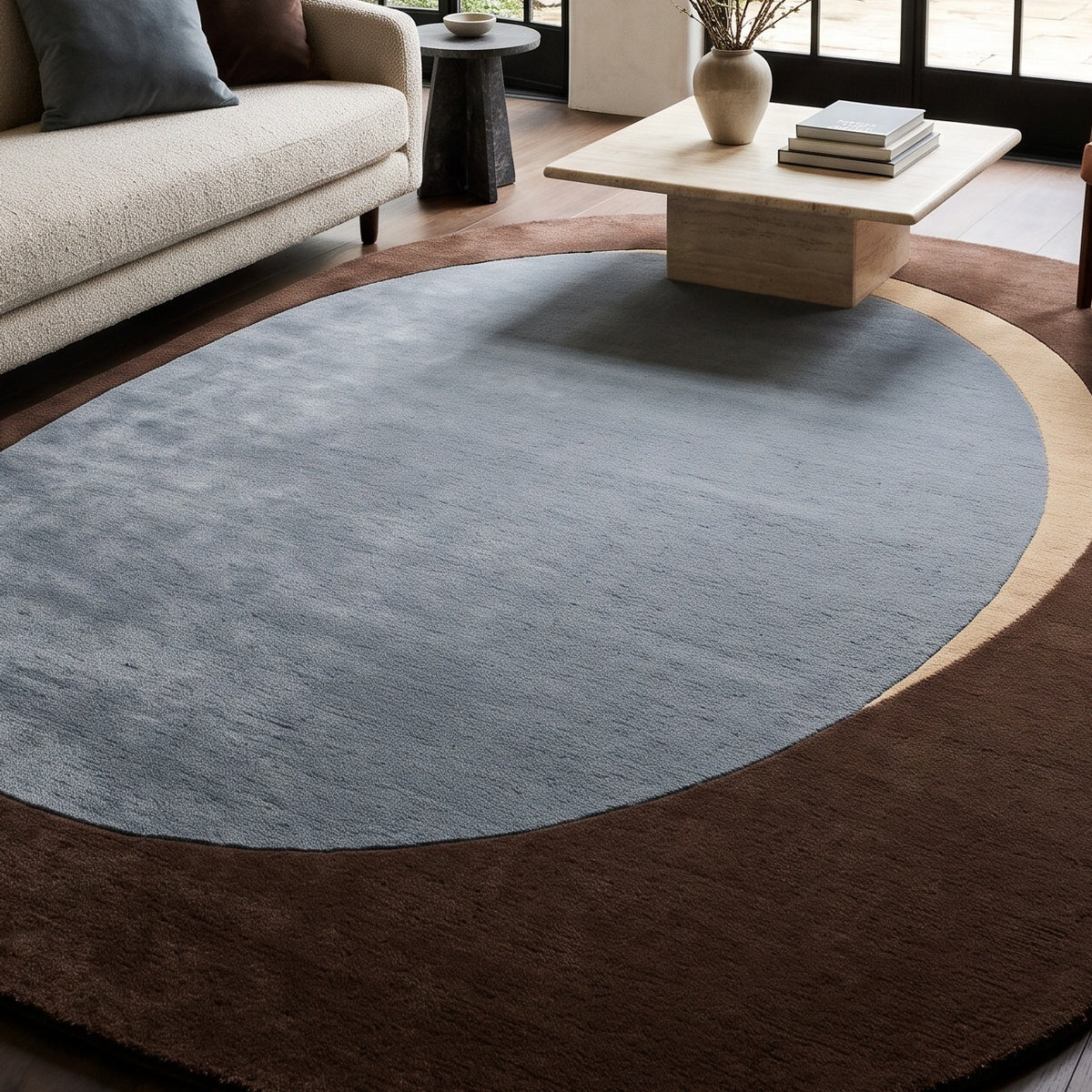 Slate Blue Oval Rug in hand-tufted wool with a slate blue oval centre, a sand crescent and a wide chocolate brown oval border - view 5