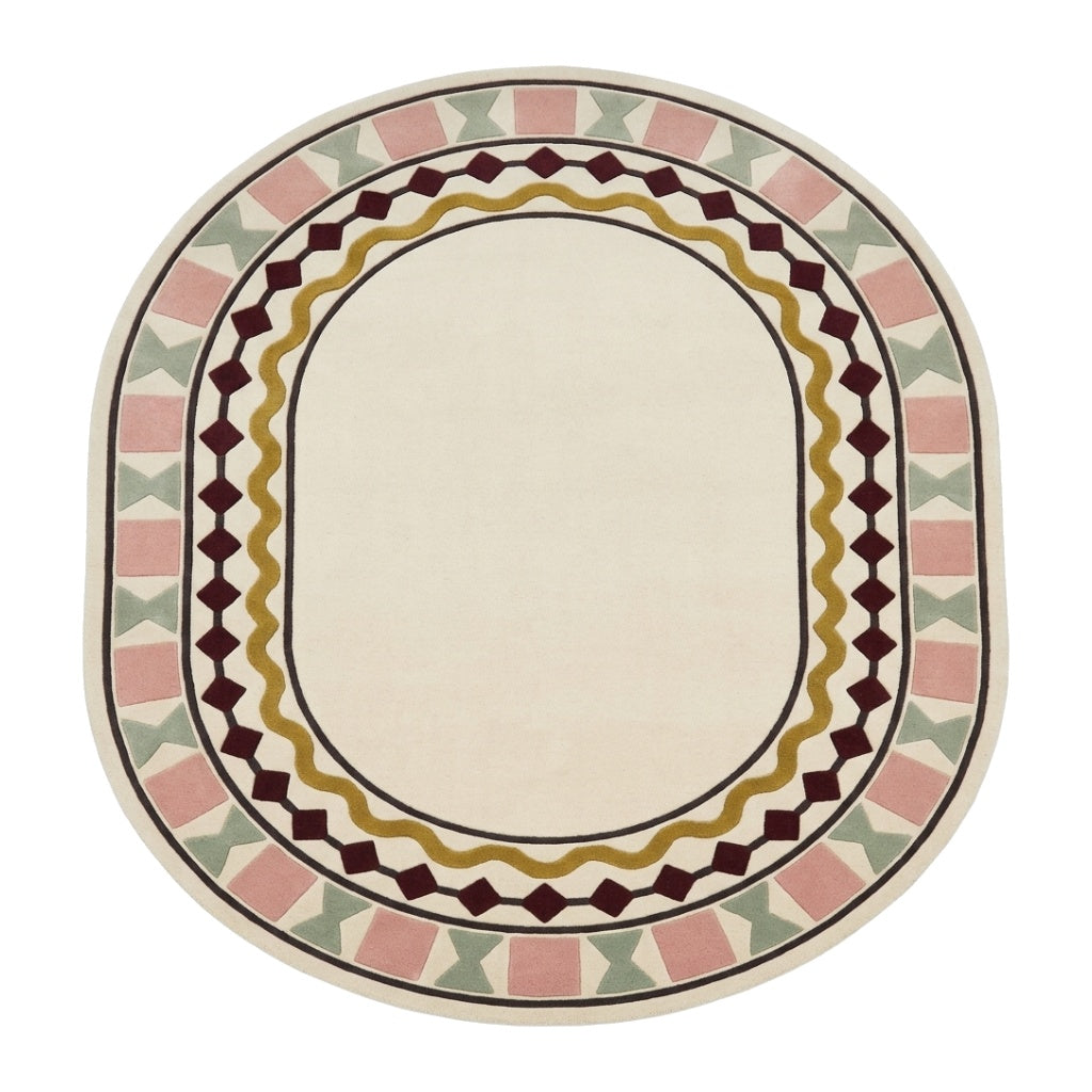 Ivory Oval Rug in hand-tufted wool with a plain ivory centre and a geometric border of burgundy diamonds, a mustard wavy line, blush squares and sage bowtie shapes - view 2
