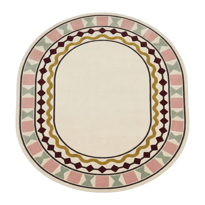 Ivory Oval Rug in hand-tufted wool with a plain ivory centre and a geometric border of burgundy diamonds, a mustard wavy line, blush squares and sage bowtie shapes - view 2
