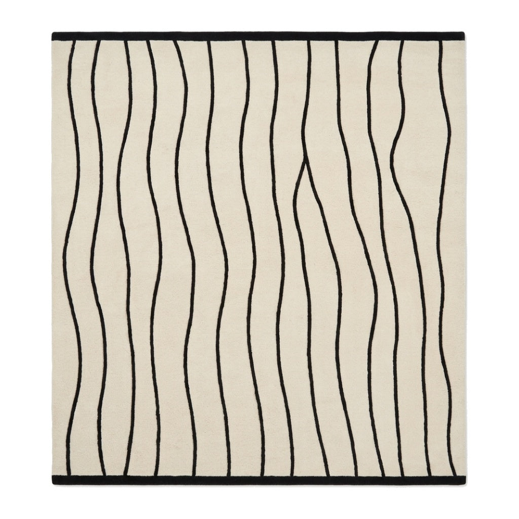 Black and White Wavy Line Rug with an ivory ground, flowing black stripes, and a crisp black border