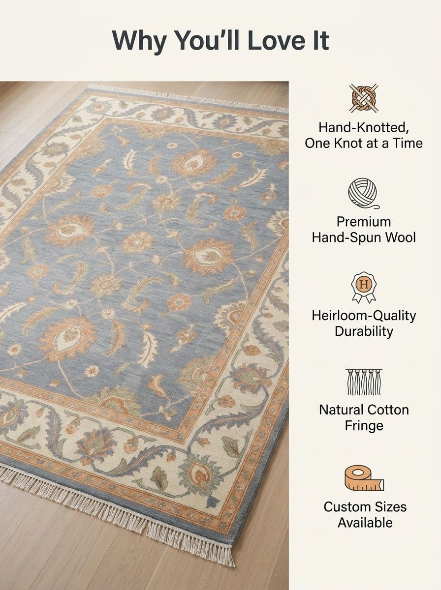 Blue Oushak Rug with a slate blue wool field, peach and ivory floral motifs, wide ivory border and cotton fringe