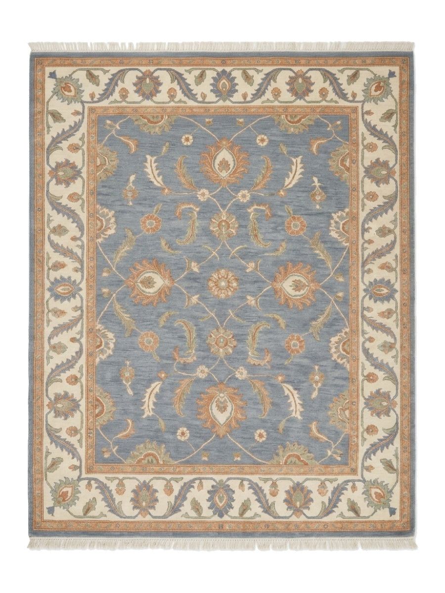Blue Oushak Rug in slate blue wool with peach and ivory floral motifs, wide ivory border and fringe