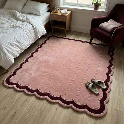 Blush Pink Fluted wool rug with carved vertical channels, scalloped pink edge and deep burgundy border.