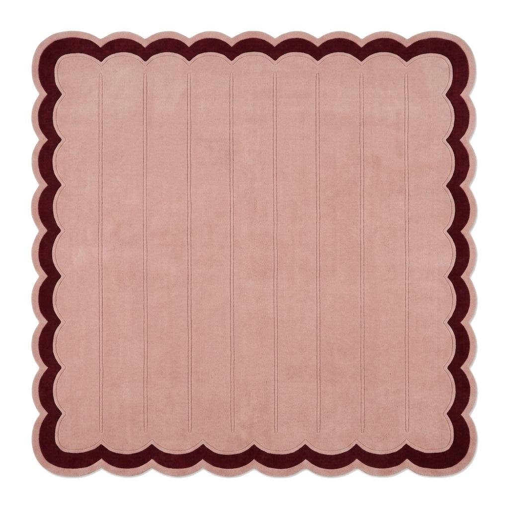 Blush Pink Fluted wool rug with carved vertical channels, deep burgundy border and scalloped edges.