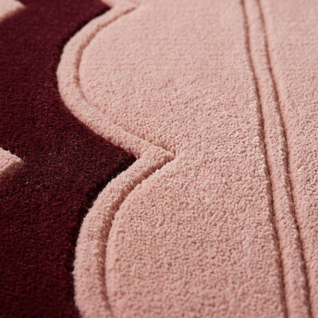 Blush Pink Fluted wool rug with plush tufted pile, sculpted scalloped edge and deep burgundy border.