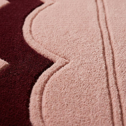 Blush Pink Fluted wool rug with plush tufted pile, sculpted scalloped edge and deep burgundy border.