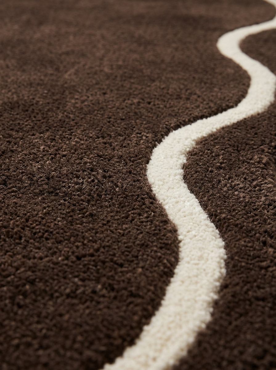 Brown Wavy Runner Rug in deep brown wool with a raised ivory wavy line curving across its textured pile