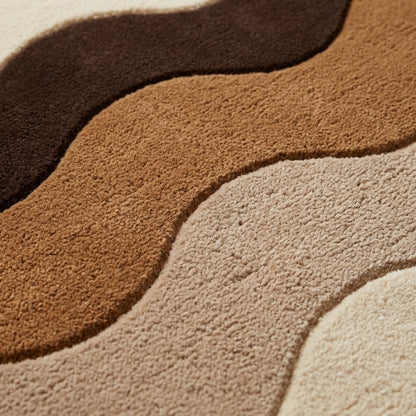 Brown Wavy Stripe Rug in plush wool with sculpted waves of chocolate brown, caramel and cream