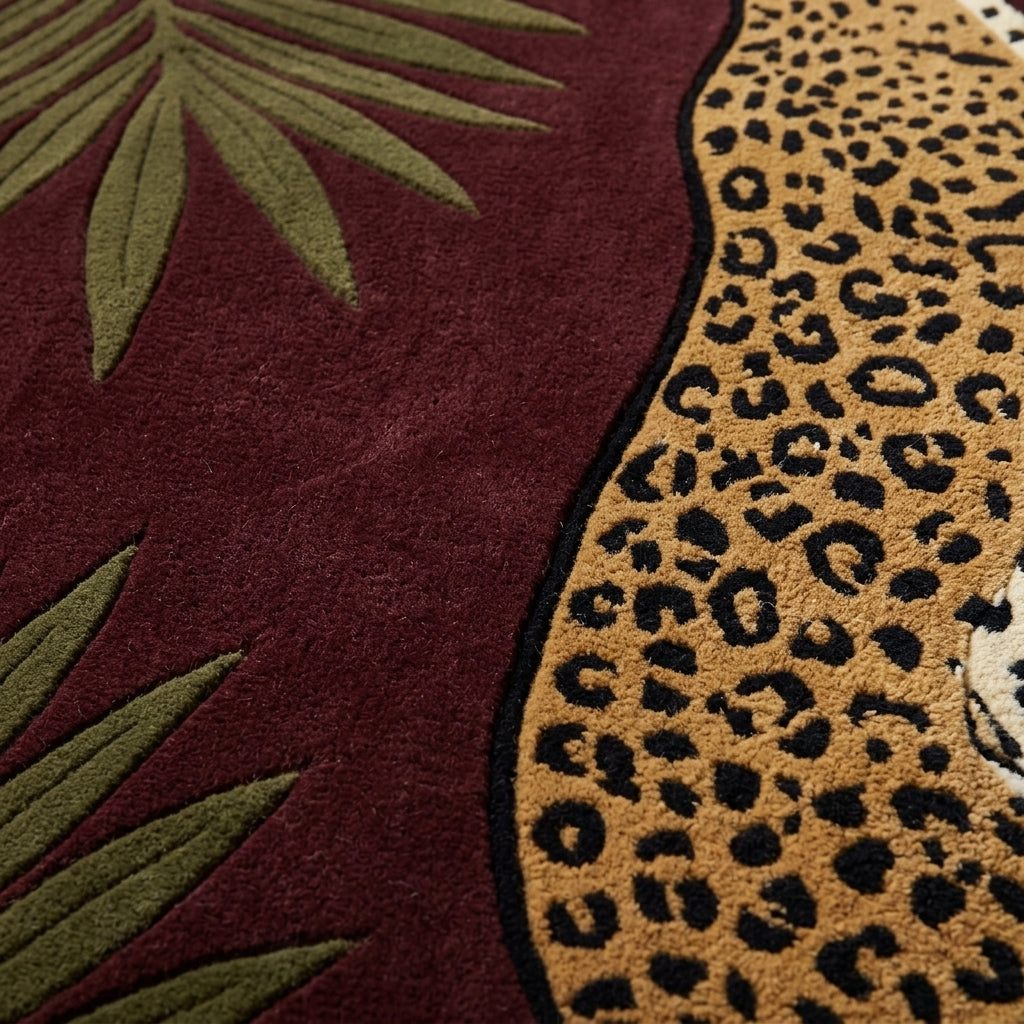 Burgundy Leopard Rug in plush burgundy wool with a tan and black spotted leopard beside olive palm leaves and sculpted edges