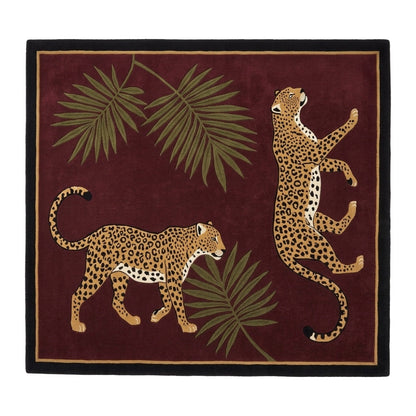 Burgundy Leopard Rug with tan spotted leopards and olive palm fronds, framed by a fine gold line and black border
