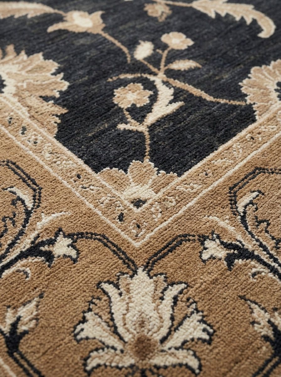 Charcoal Oushak Rug in wool with a dark charcoal field, camel border, and ivory floral vines and palmettes