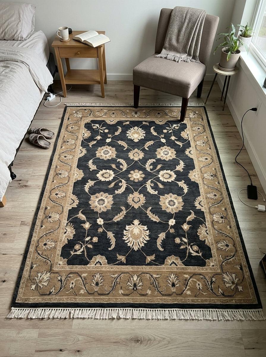 Charcoal Oushak Rug in wool with ivory and camel floral motifs, a wide camel border and fringed edges