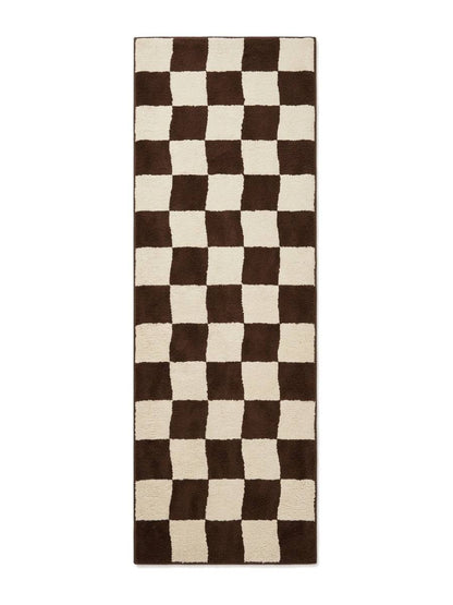 Checkered Runner Rug in chocolate brown and ivory wool, featuring an irregular checkerboard pattern and bound edges