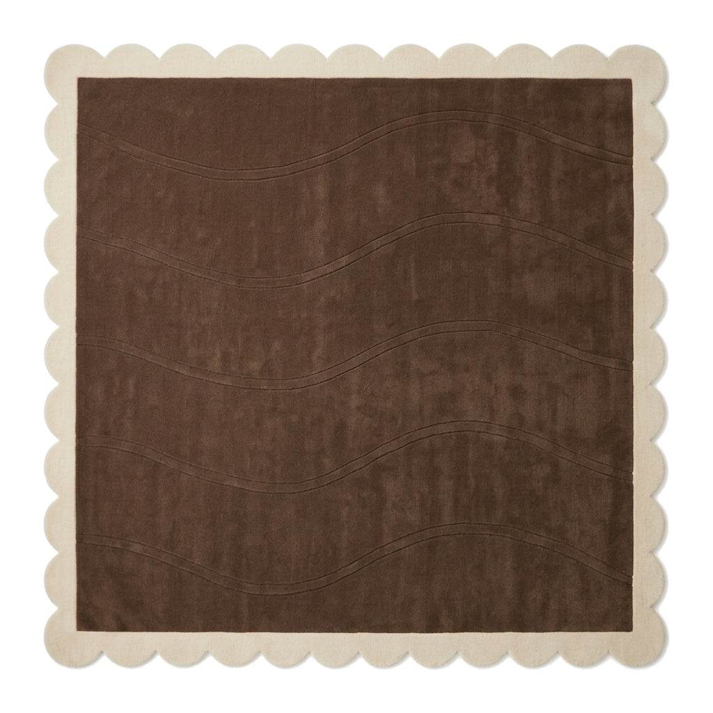 Chocolate Brown Wave rug in plush wool, with carved flowing lines and a cream scalloped border.