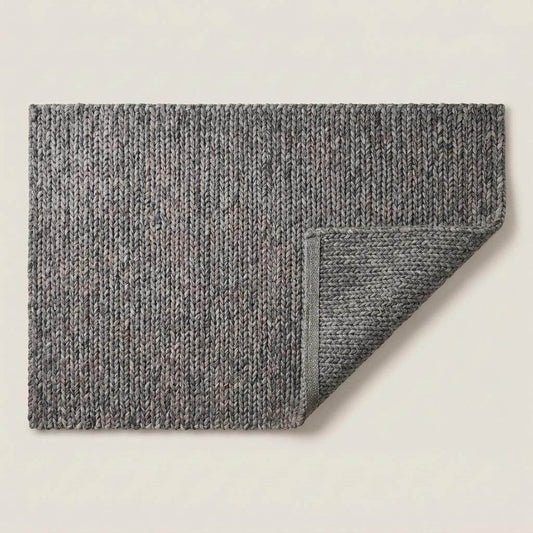 Handwoven chunky knit wool rug in gray with oversized braid design for modern Scandinavian living room decor