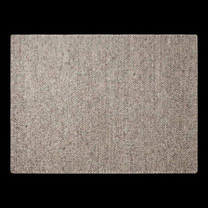 Chunky wool area rug in neutral beige with thick textured weave for cozy minimalist living room decor