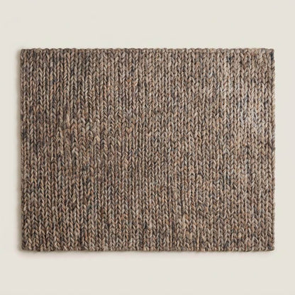 Handwoven chunky wool area rug with thick braided texture in neutral brown tones for modern farmhouse decor