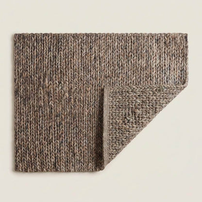 Handwoven chunky wool area rug with thick braided texture in neutral brown, perfect for modern farmhouse and minimalist decor.