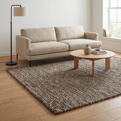 Handwoven chunky wool area rug with thick braided texture in neutral brown tones for modern farmhouse decor