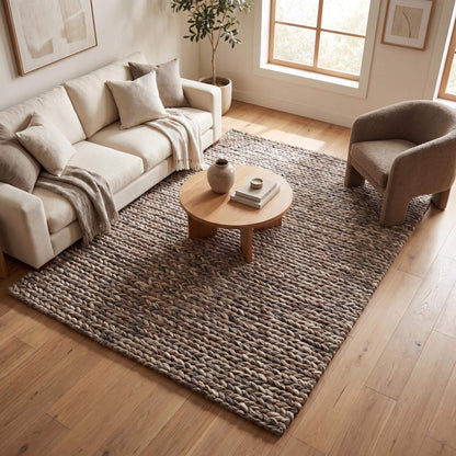 Handwoven chunky wool area rug with thick braided texture in neutral brown, perfect for modern farmhouse and minimalist decor