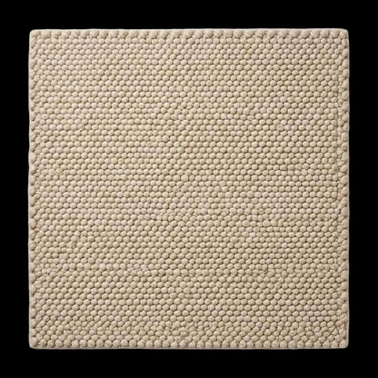 Handwoven chunky wool pebble rug in ivory with textured pebble weave for modern minimalist decor