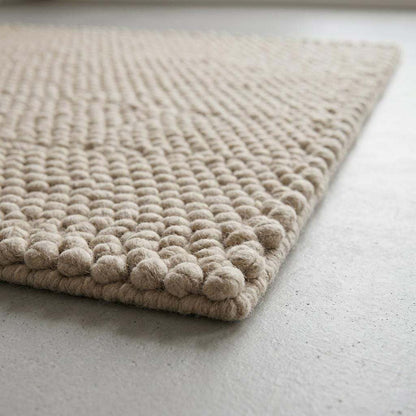 Handwoven chunky wool pebble rug in ivory with textured pebble weave for modern minimalist decor