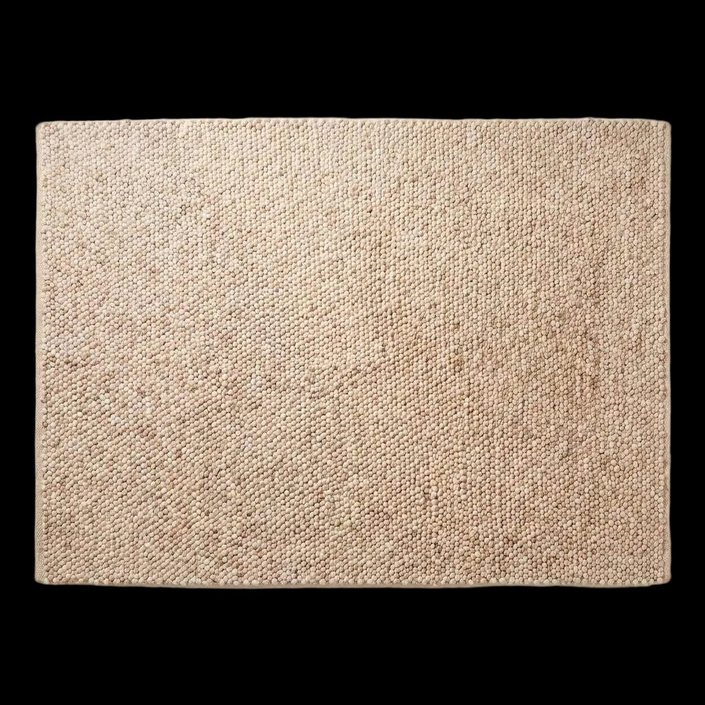 Chunky wool pebble rug in neutral beige with textured pebble weave, minimalist modern living room décor