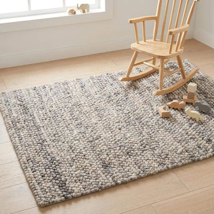Handwoven chunky wool pebble rug in neutral tones, perfect for modern Scandinavian living rooms