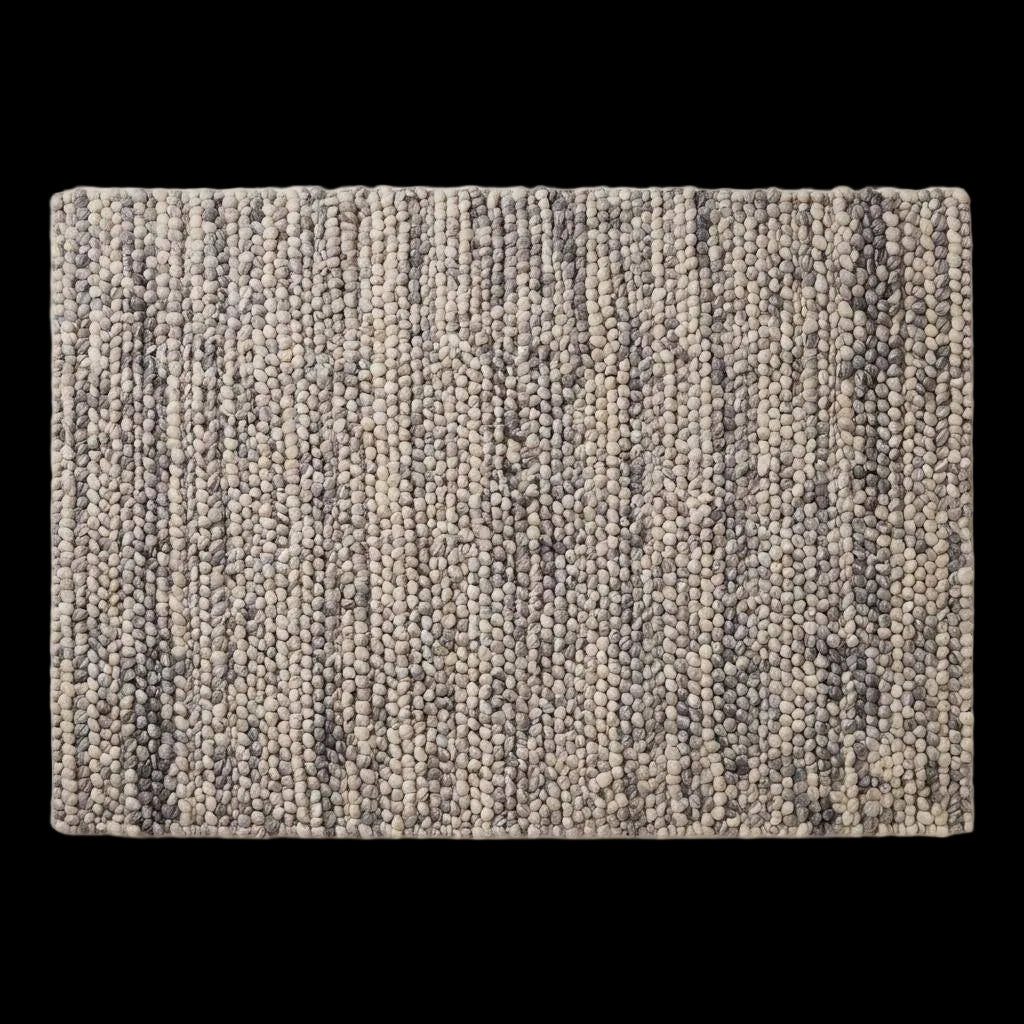 Handwoven chunky wool pebble rug in neutral tones, perfect for modern Scandinavian living room decor