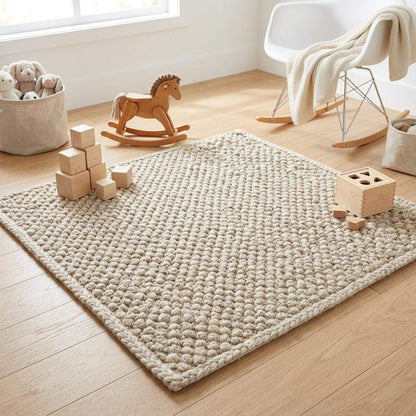 Handwoven chunky wool pebble rug in neutral tones for cozy Scandinavian living room decor