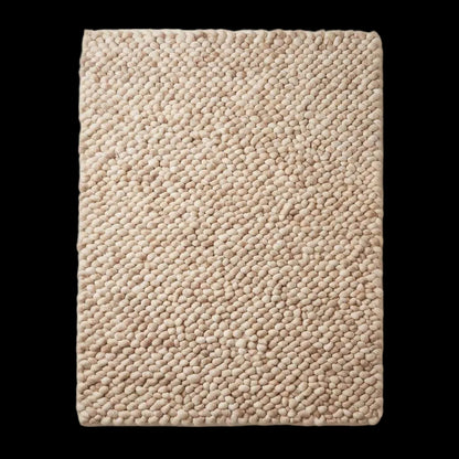Handmade chunky wool rug with thick knit texture in neutral beige for cozy living room and bedroom decor