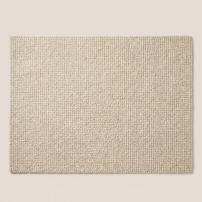 Handmade chunky wool rug with soft, thick texture in neutral tones for cozy minimalist living room decor