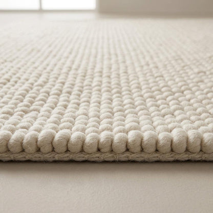 Chunky Wool Rug in ivory cream, with a thick, tightly looped braided knit texture and neatly finished edges.