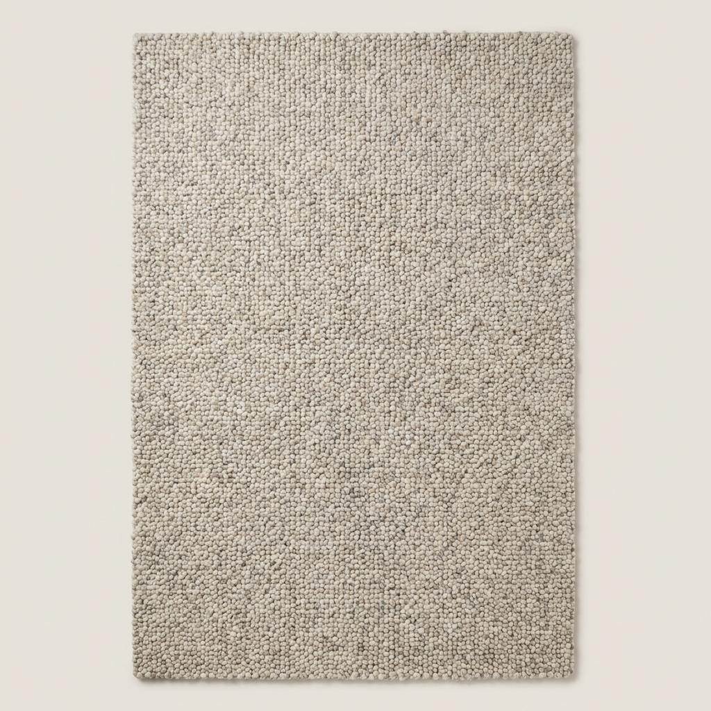 Chunky wool rug with handwoven pebble texture in neutral ivory for Scandinavian minimalist living room