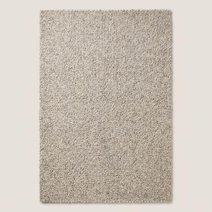 Chunky wool rug with handwoven pebble texture in neutral ivory for Scandinavian minimalist living room