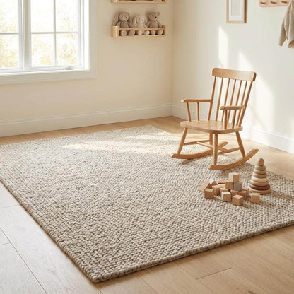 Chunky wool rug with handwoven pebble texture in neutral ivory tones for Scandinavian minimalist decor