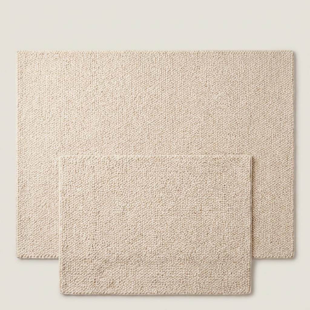 Chunky wool rug with thick handwoven loop pile in neutral cream for cozy minimalist home decor