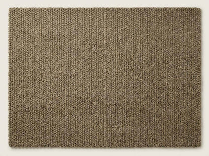 Chunky wool rug with thick loop pile in neutral tones, cozy handmade textured area rug for farmhouse decor