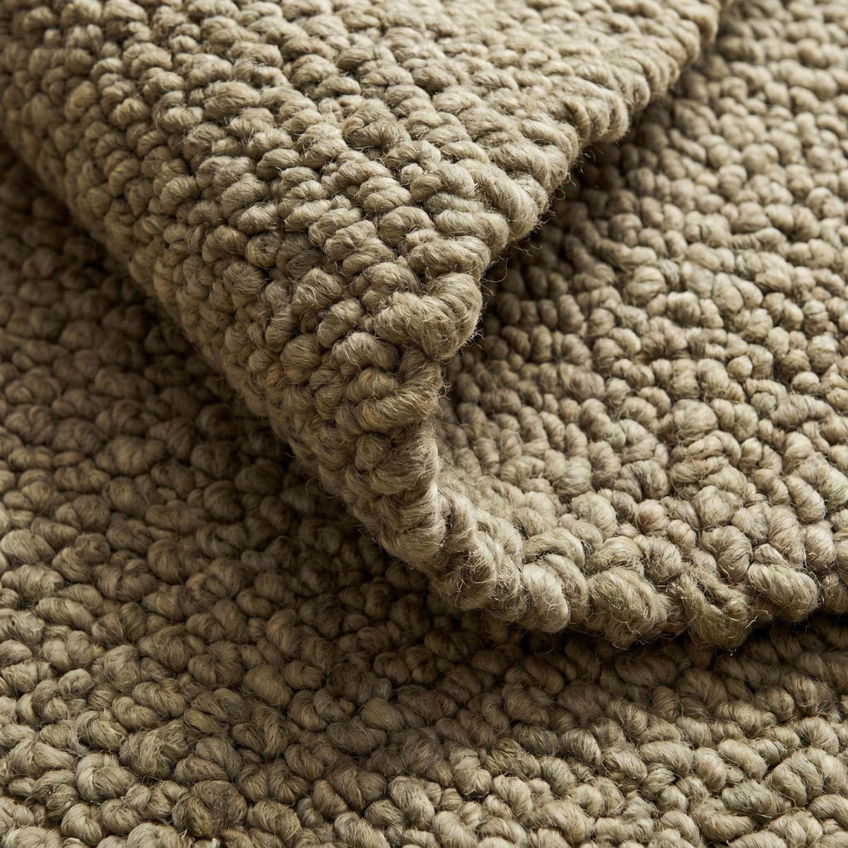 Chunky wool rug with thick loop pile and neutral textured weave for cozy farmhouse decor