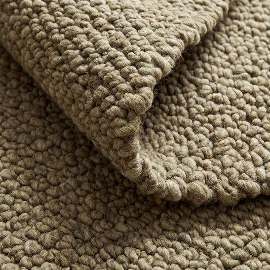 Chunky wool rug with thick loop pile and neutral textured weave for cozy farmhouse decor