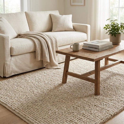 Handwoven chunky wool rug in neutral tones with thick loop pile for cozy minimalist farmhouse decor