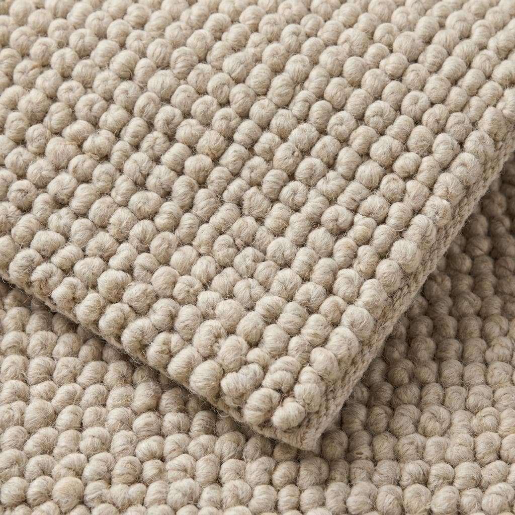 Chunky wool rug with neutral tones and handwoven thick loop pile for cozy minimalist farmhouse and Scandinavian decor